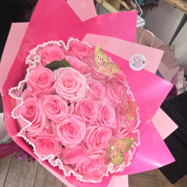 Bouquet of pink roses wrapped in bright pink paper