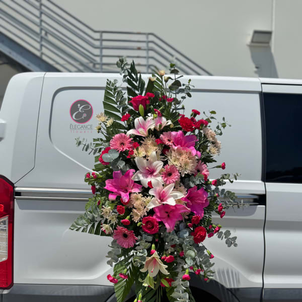 Tall pink and white floral spray with lilies and daisies