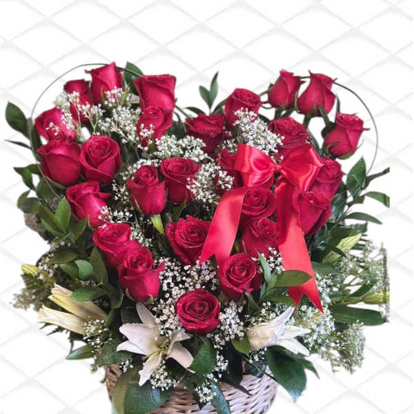 Red rose bouquet with white filler flowers in a wicker basket