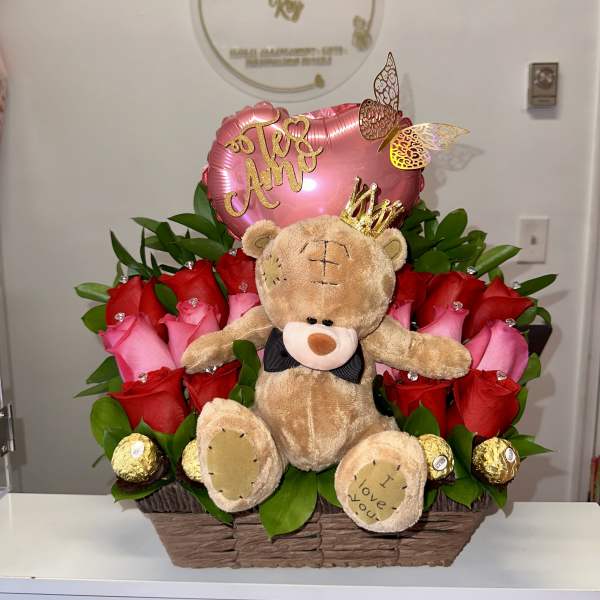 Basket arrangement of red and pink roses with a teddy bear and heart balloon