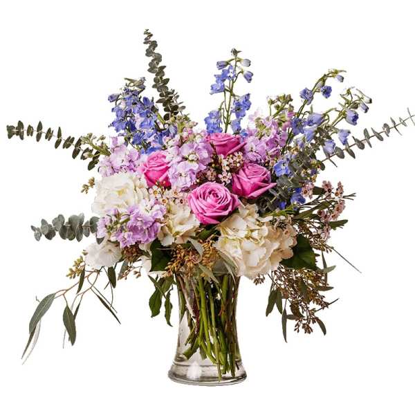 Pink roses and lavender flowers in a clear glass vase