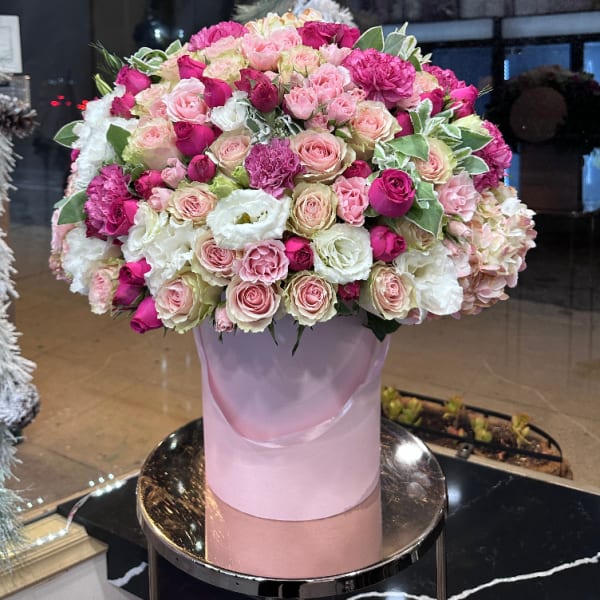 Large pink and white rose arrangement in a pastel box