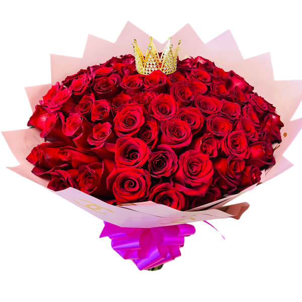 Bouquet of red roses with a small crown topper and pink wrapping