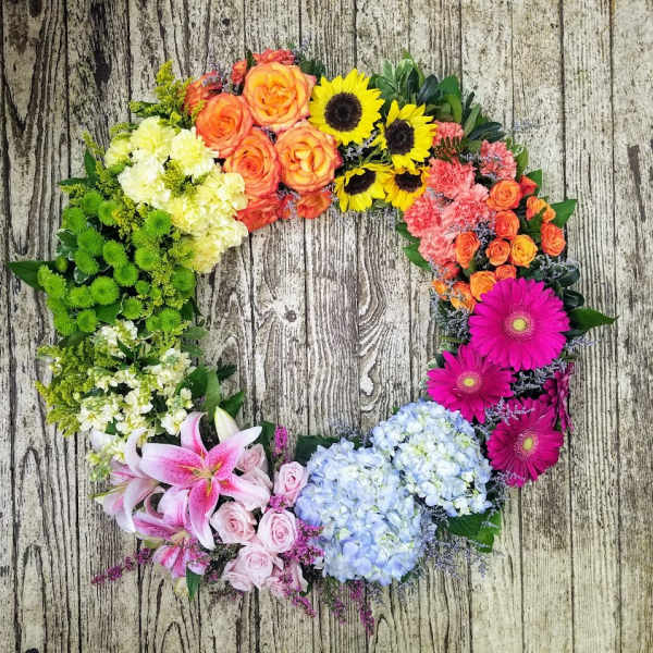 Circular floral wreath with mixed blooms in bright colors