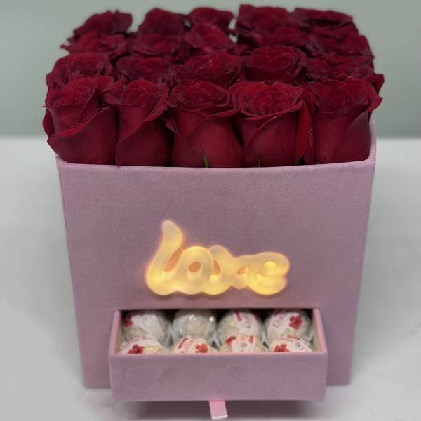 Pink box of red roses with a drawer of chocolates