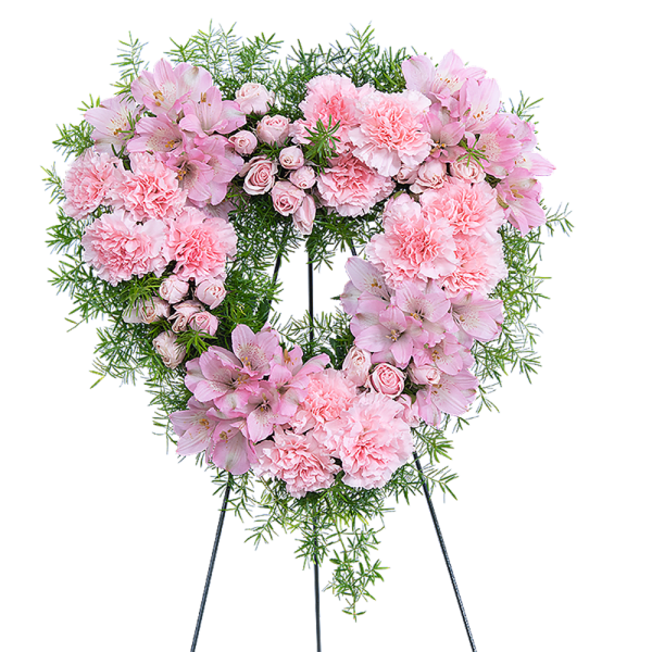 Heart-shaped pink floral wreath on a stand