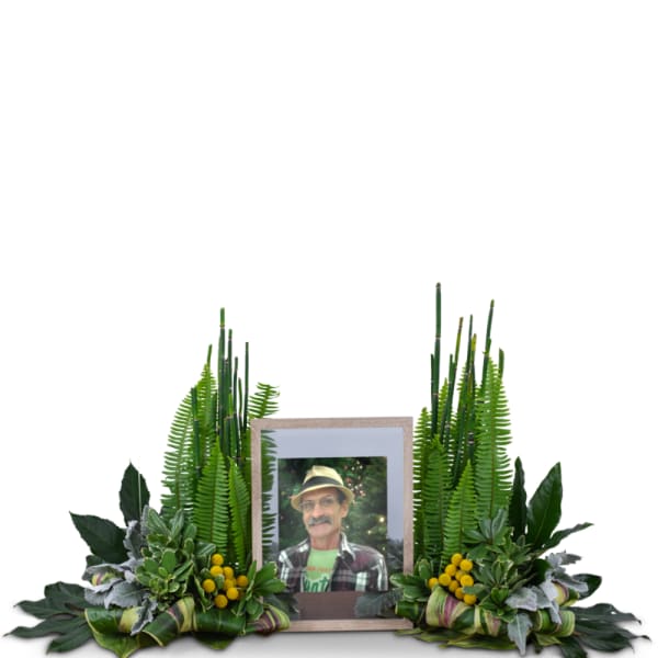 Framed photo surrounded by green foliage and yellow berry accents