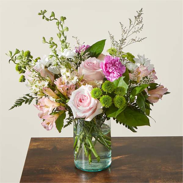 Pink and white mixed flower bouquet in a clear glass vase