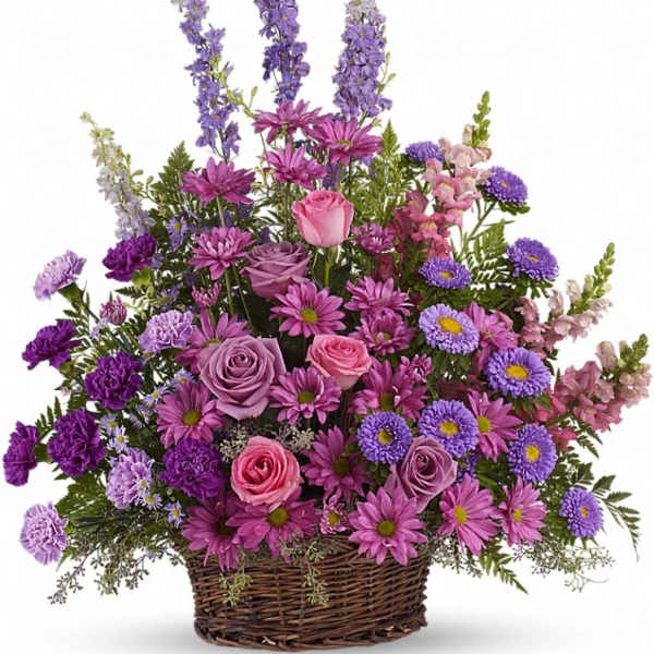 Tall basket arrangement of purple and pink roses, daisies, carnations, asters, and snapdragons