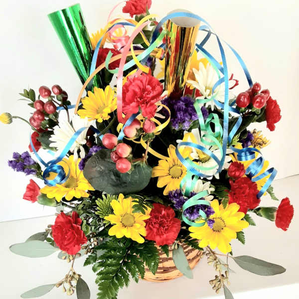 Colorful flower basket with ribbon curls and metallic party horns