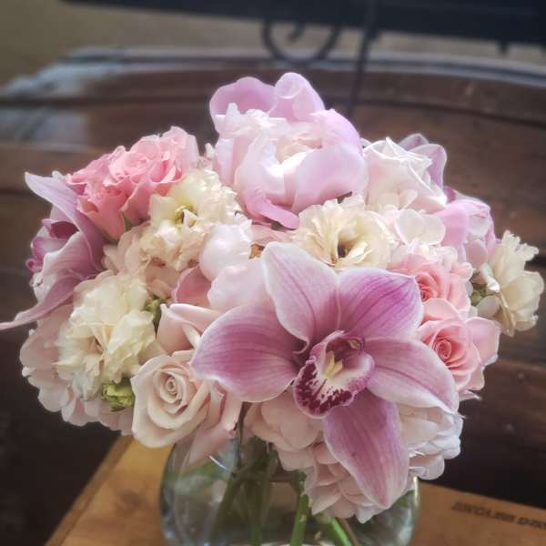 Pink and white bouquet in a clear glass vase