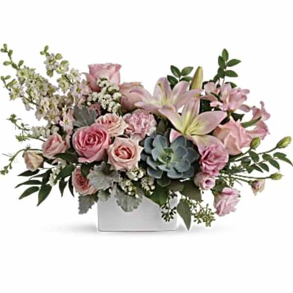 Low pink rose and lily arrangement with a succulent in a white rectangular vase
