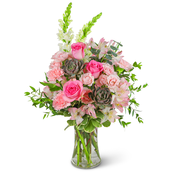 Pink roses and carnations in a clear glass vase with white snapdragons