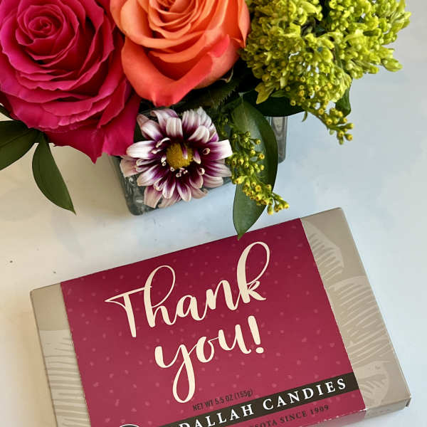 Flowers beside a thank-you candy box