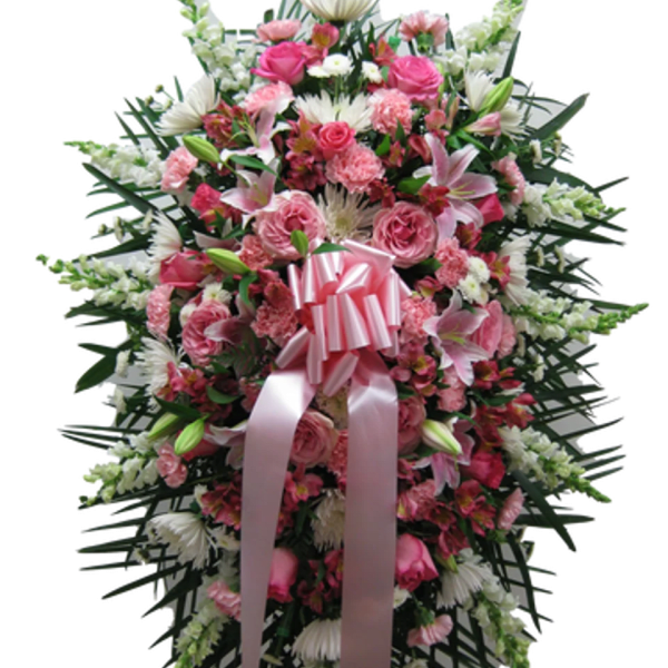 Tall standing spray with pink and white flowers and a large pink ribbon bow