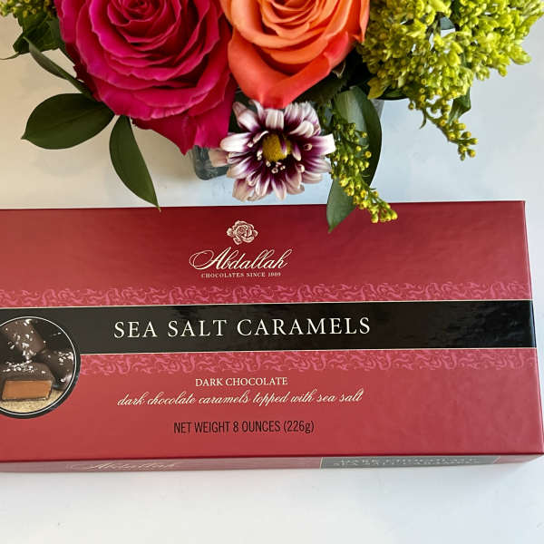 Bouquet above a box of sea salt caramels