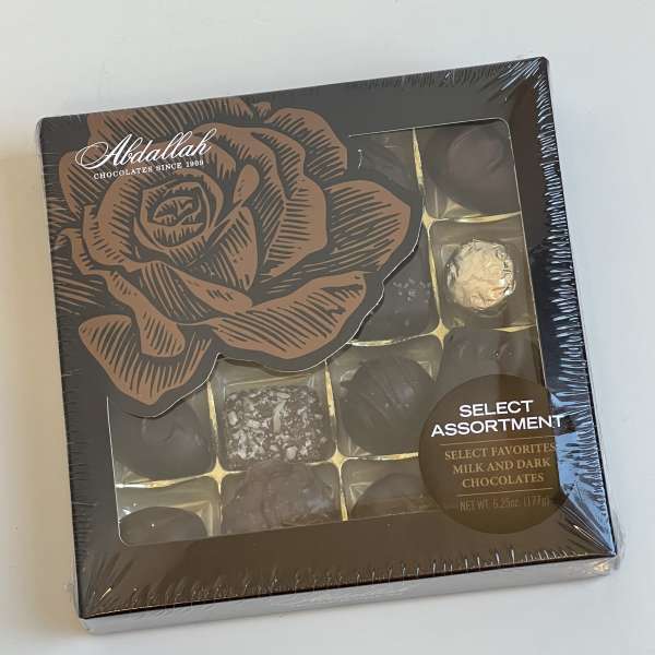 Box of assorted milk and dark chocolates with a rose design on the lid