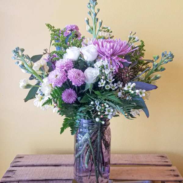 Lavender and white mixed bouquet in a glass jar vase