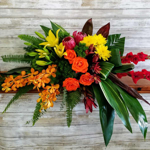 Tropical bouquet with orange roses, yellow lilies, and red orchids
