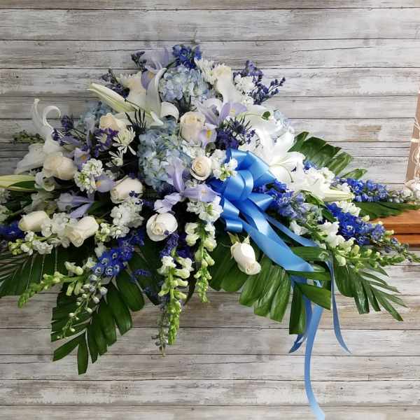 Large white and blue floral spray with a blue ribbon