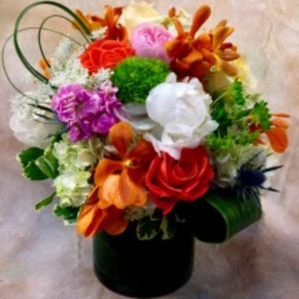 Colorful mixed flower arrangement in a black vase