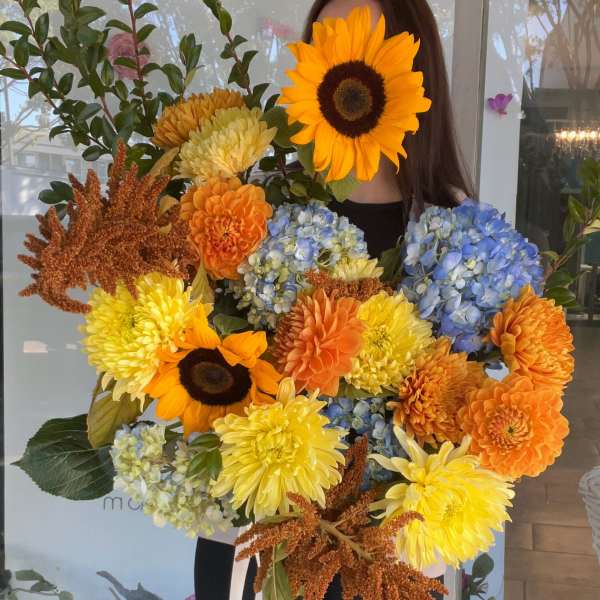 Large bouquet with sunflowers, dahlias, hydrangeas, and orange blooms