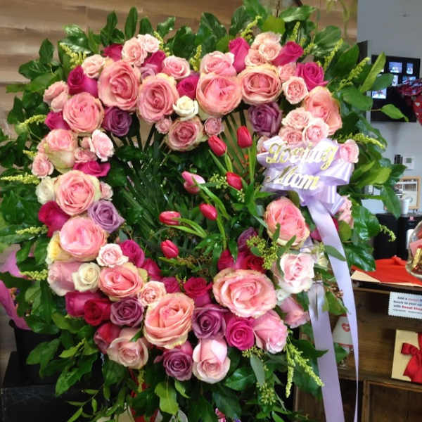 Large heart-shaped rose wreath with a lavender ribbon reading Loving Mom