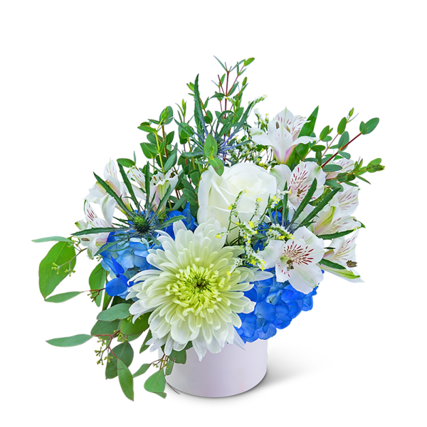 White and blue floral arrangement in a white container