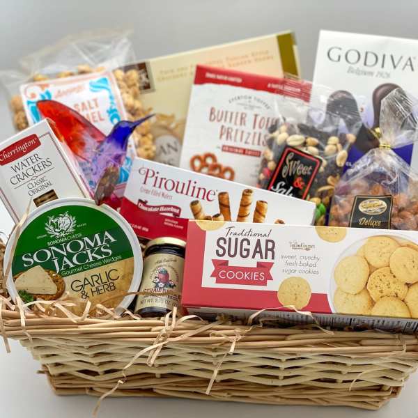 Gift basket filled with assorted packaged snacks and cookies