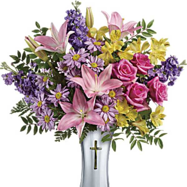 Pink lilies, roses, and purple daisies in a silver vase
