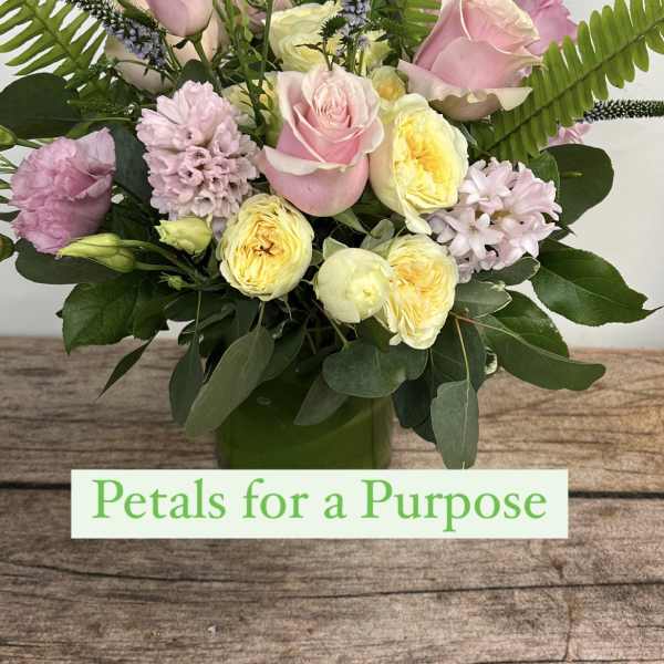 Pink and yellow mixed bouquet in a green vase