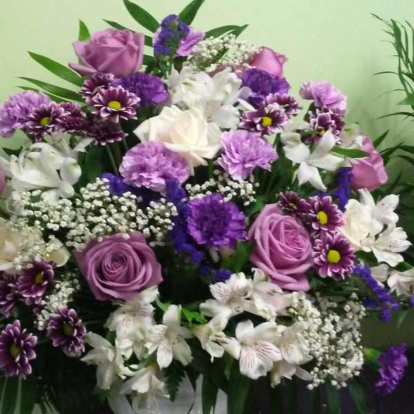 Bouquet of purple and white roses with mixed purple flowers