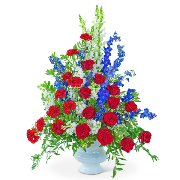 Red roses, red carnations, and blue delphinium in a white vase