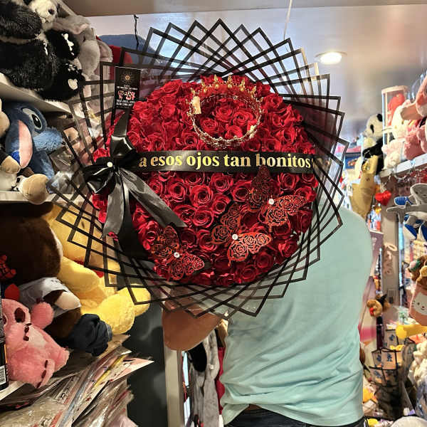 Heart-shaped bouquet of red roses with black ribbon and butterfly accents