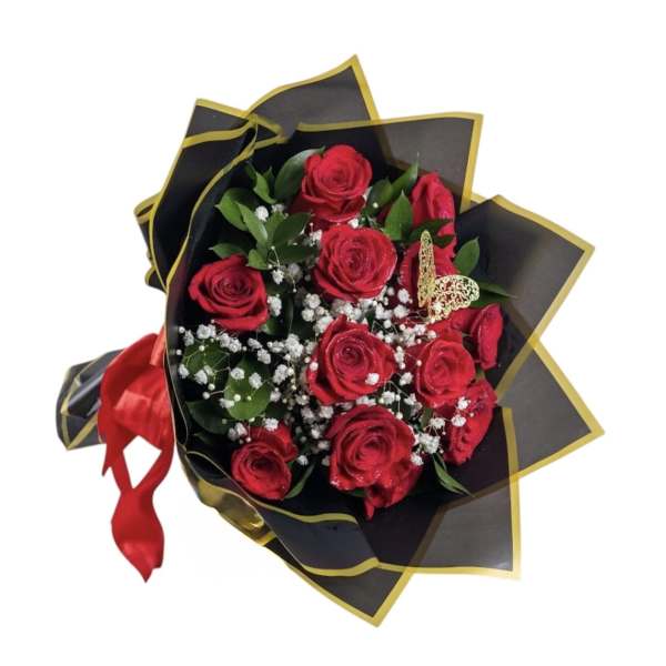 Bouquet of red roses wrapped in black paper with gold trim