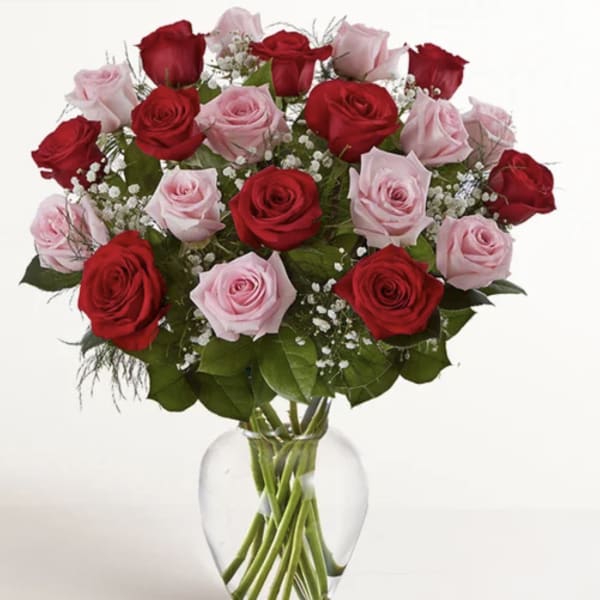 Bouquet of red and pink roses in a clear glass vase