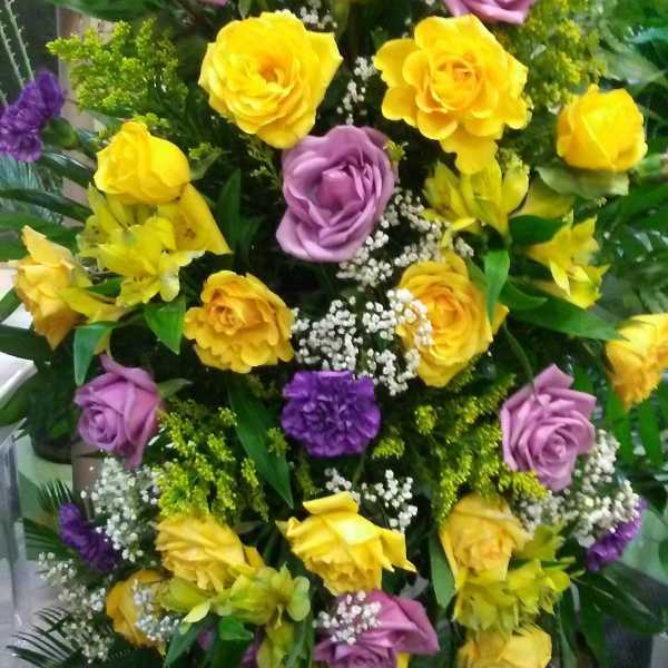 Tall bouquet of yellow and lavender roses with purple accents