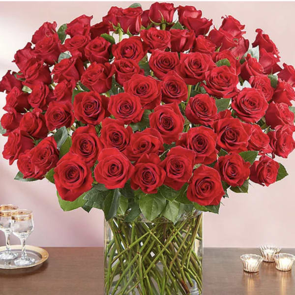 Large bouquet of red roses in a clear glass vase