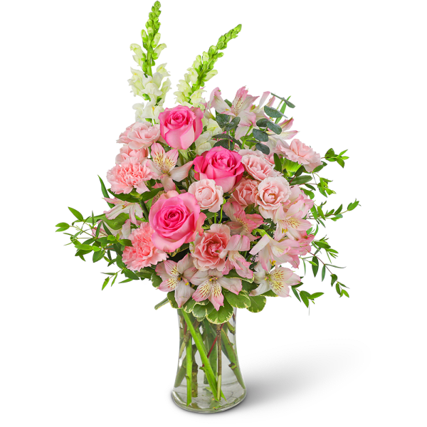 Pink roses and carnations in a clear glass vase