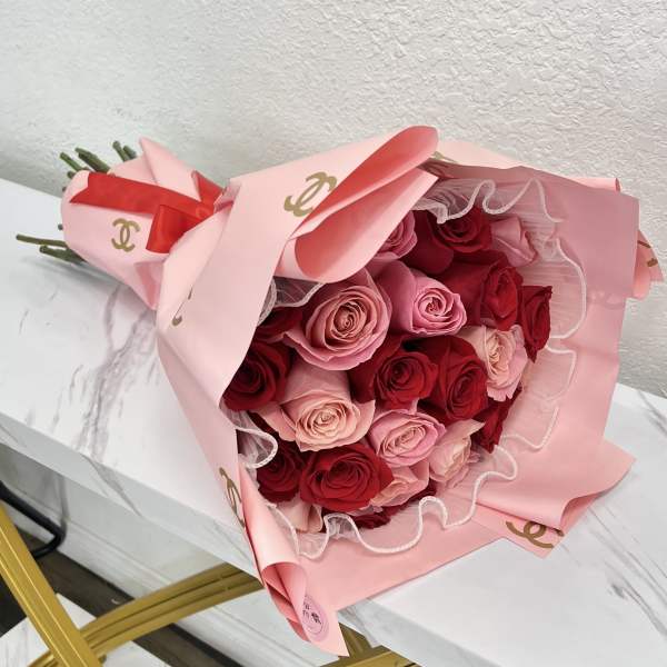 Bouquet of red and pink roses wrapped in pink paper