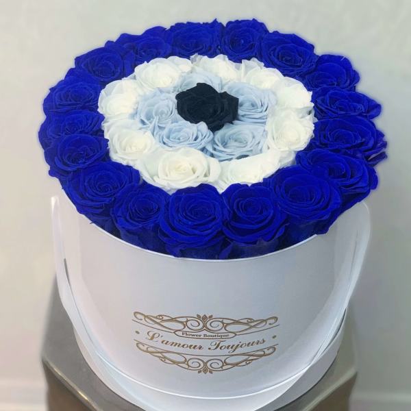 Round box of blue, white, and black roses