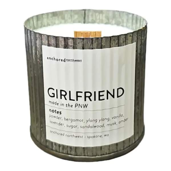 Scented candle in a rustic metal tin labeled Girlfriend
