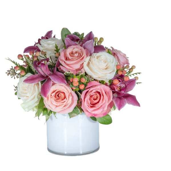 Pink and white roses with purple orchids in a glass vase
