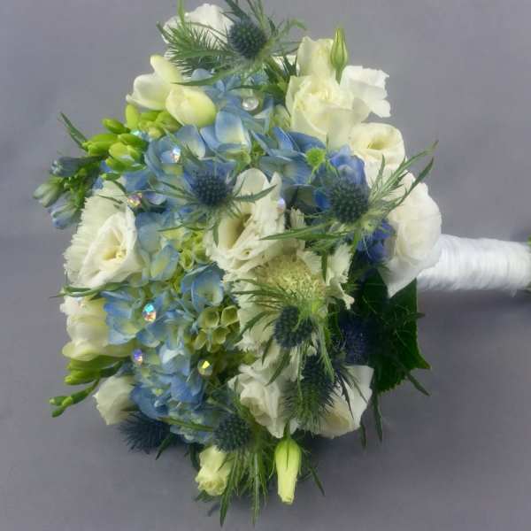 Blue and white bridal bouquet with spiky thistles and wrapped stems