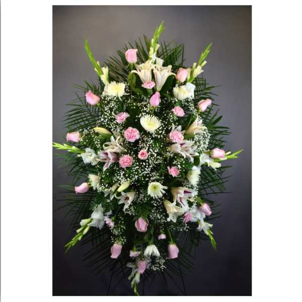 Tall standing floral spray with pink and white flowers on a dark background