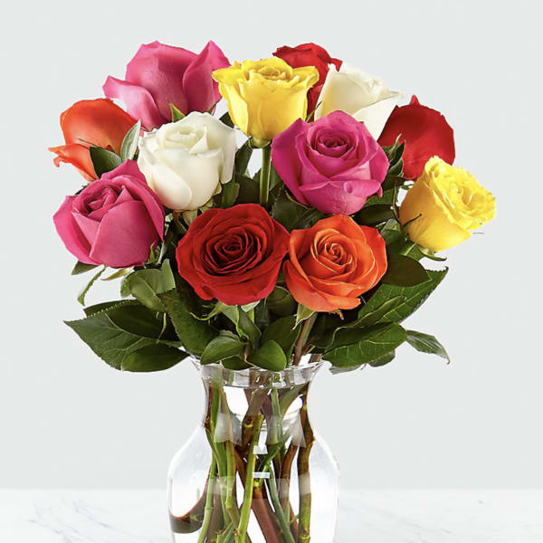 Bouquet of multicolored roses in a clear glass vase