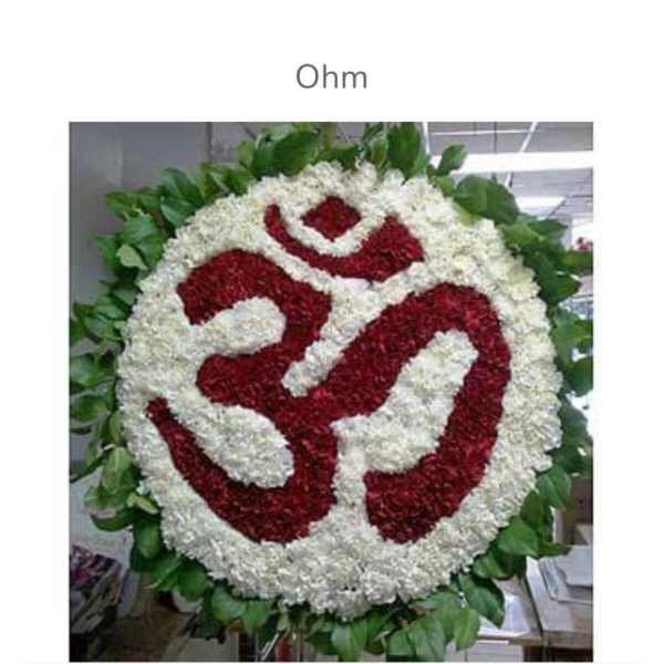 Round floral wreath with a red and white symbol in the center