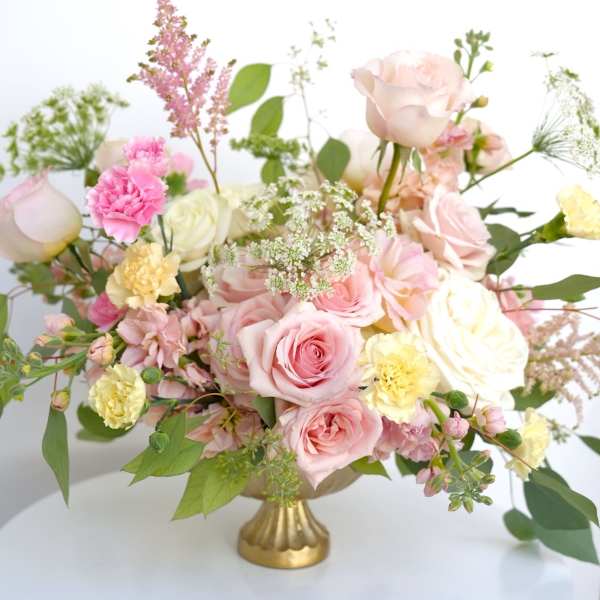 Pink and cream rose bouquet in a gold vase