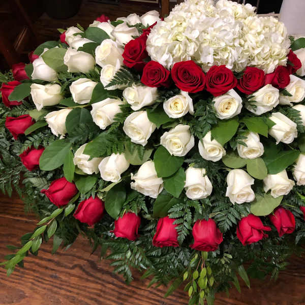 Large arrangement of red and white roses with white hydrangeas