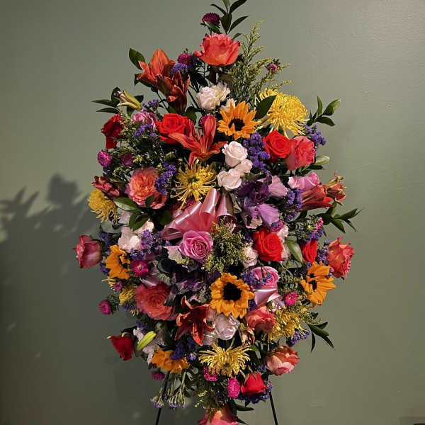 Large colorful standing floral spray on an easel